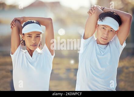Fitness, flexible and couple stretching at a park before they start training, workout and exercise together in summer. Flexibility, wellness and young Stock Photo