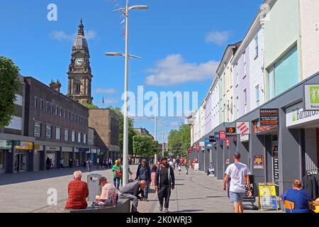 Summer shoppers in Bolton town centre, Oxford street, with town hall in the background, looking north Stock Photo