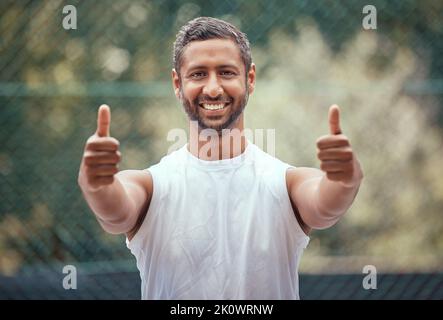 Happy yes thank you or success thumbs up of a sports man with a smile on a tennis court. Winner, happiness or target goal completion celebration hand Stock Photo