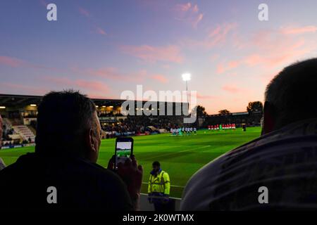 A Sheffield Wednesday fan takes a photo as the teams hold a minutes silence as a mark of respect following the death of HRH Queen Elizabeth II during the Sky Bet League 1 match Morecambe vs Sheffield Wednesday at Mazuma Stadium, Morecambe, United Kingdom, 13th September 2022  (Photo by Steve Flynn/News Images) Stock Photo