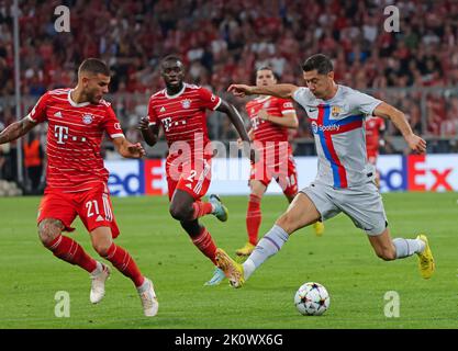 Munich, Germany. 13th Sep, 2022. Robert Lewandowski (1st, R) of Barcelona breaks through during the UEFA Champions League Group C match between Bayern Munich and FC Barcelona in Munich, Germany, on Sept. 13, 2022. Credit: Philippe Ruiz/Xinhua/Alamy Live News Stock Photo