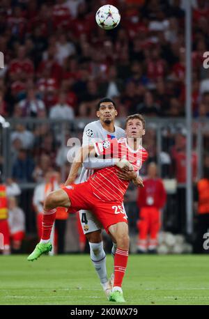 Munich, Germany. 13th Sep, 2022. Ronald Araujo (back) of Barcelona vies with Thomas Mueller of Bayern Munich during the UEFA Champions League Group C match between Bayern Munich and FC Barcelona in Munich, Germany, on Sept. 13, 2022. Credit: Philippe Ruiz/Xinhua/Alamy Live News Stock Photo