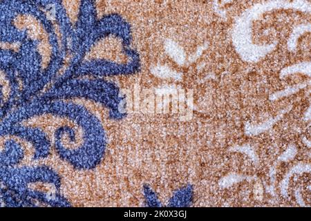 Light brown color carpet with blue and white color design texture background closeup view Stock Photo