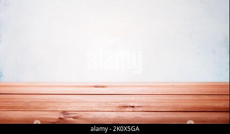 Wood table and white empty wall in home interior for product placement stand. Floor desk display mockup. Room shelf, kitchen board counter background. Stock Photo