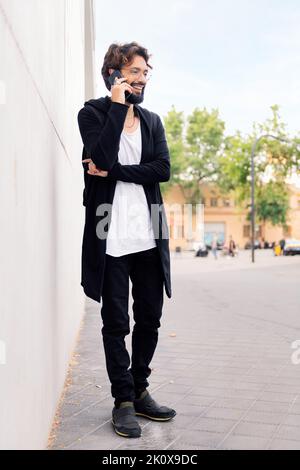 smiling young man talking on mobile phone Stock Photo