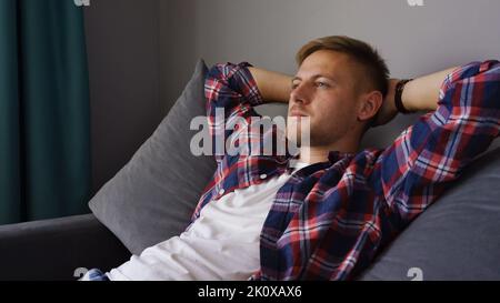 A young man resting on the couch Stock Photo