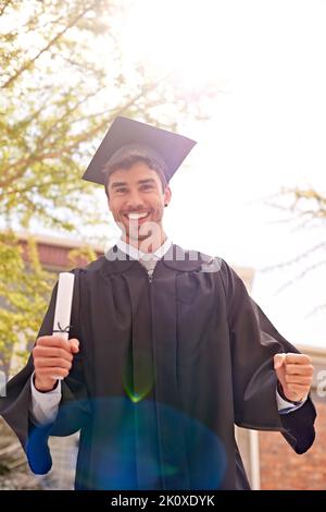 Portrait of a young male graduate holding a diploma and his parents in ...