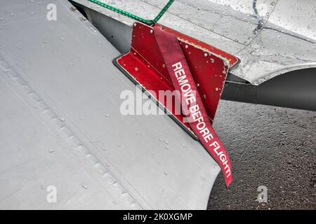 A remove before flight ribbon on a airplane Stock Photo
