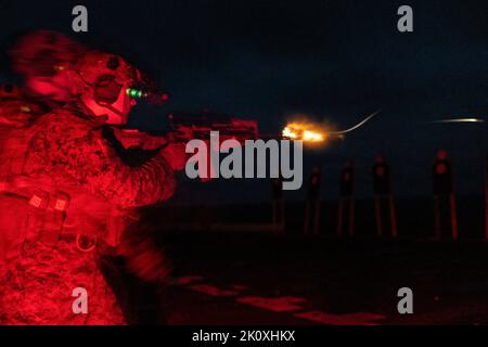 September 3, 2022 - Sea of Japan - A U.S. Marine with Battalion Landing Team 2/5, 31st Marine Expeditionary Unit, fires during a deck shoot aboard USS New Orleans (LPD 18) in the Sea of Japan, Septembertemberember. 3, 2022. The Combat Marksmanship Program is designed to sustain a unit's lethality. The 31st MEU is operating aboard ships of the Tripoli Amphibious Ready Group in the 7th fleet area of operations to enhance interoperability with allies and partners and serve as a ready response force to defend peace and stability in the Indo-Pacific Region. (Credit Image: © U.S. Marines/ZUMA Press Stock Photo