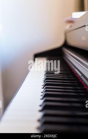 Classic grand piano keyboard close-up. Close-up of a wooden piano and piano keys. Selective focus and soft focus. Frontal view, shallow depth of field Stock Photo