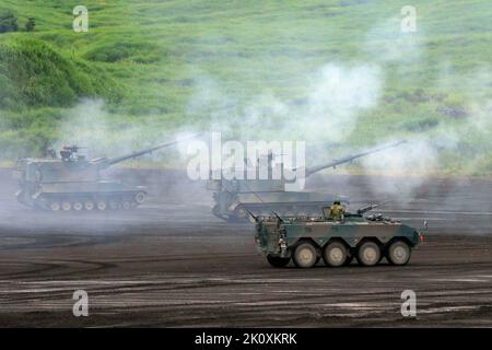 JGSDF The Type 99 155 mm self-propelled howitzer, Type 96 Armored Personnel Carrier foreground. Stock Photo