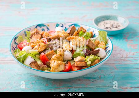 Healthy Grilled Chicken Caesar Salad with Cheese and Croutons Stock Photo