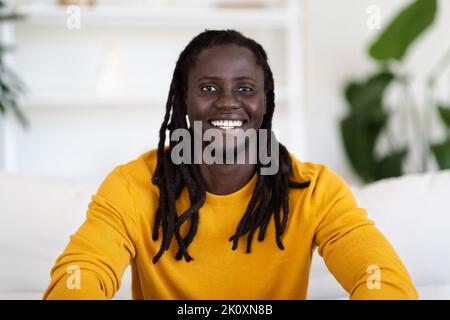 Portrait Of Smiling Young Black Male Posing In Home Interior Stock Photo