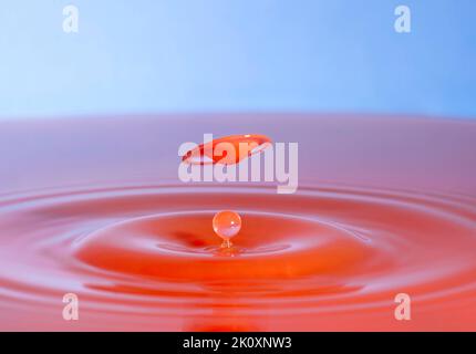 Flying disk, high-speed photography of drops of water hitting a water surface, drop photography in the studio Stock Photo