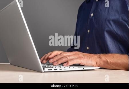 Man hands typing on laptop keyboard. Male writing e-mail, preparing report, research, browsing Internet. Using computer in work and study. High qualit Stock Photo