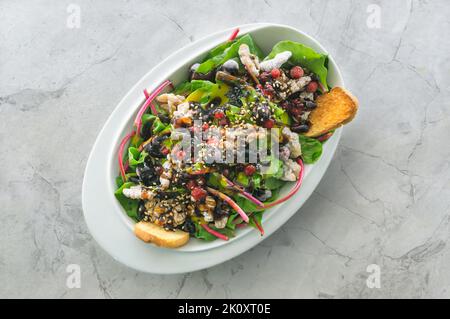 Fresh chard salad, caramelized walnuts, forest fruits. cherry tomato confit and honey Stock Photo