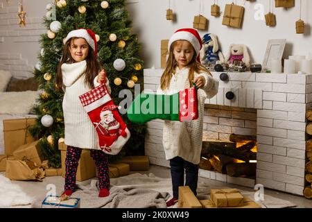 two little girls Sharing a Surprise on Christmas Morning Stock Photo