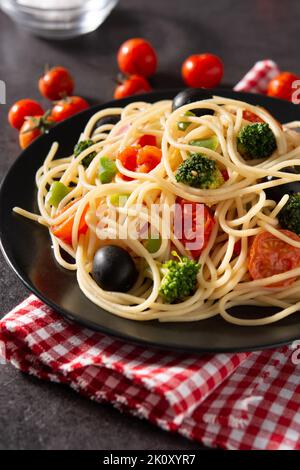 Spaghetti with vegetables(broccoli,tomatoes,peppers) on black background. Close up Stock Photo