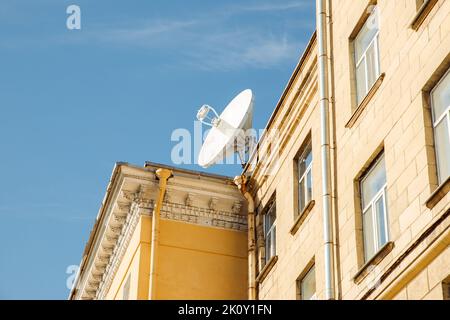 Large satellite dish or satellite antenna on building roof. Sunny day. Stock Photo