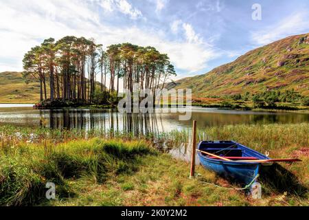 The tiny island of Eilean na Moine was the island that held Dumbledore’s Grave and is framed by surrounding Loch Eilt used multiple times in the makin Stock Photo