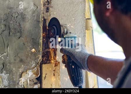 young master repairing old garage doors. handyman repairing a rotten ...