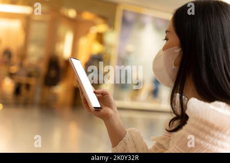 Close-up image of female hand using mobile smartphone with blank white screen. concept of searching or social networks. Stock Photo