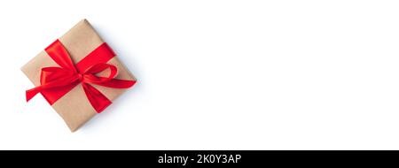 A gift box with a red ribbon on a white background. The concept of holidays. Stock Photo