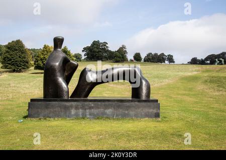 A view of Henry Moore's 'Reclining figure: Arch Leg' bronze sculpture comprising two highly simplified forms to suggest a body at the YSP, Wakefield Stock Photo