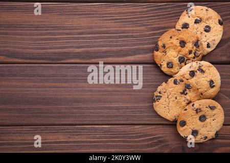 Chocolate cookies on brown background. Chocolate chip cookies on brown wooden table Stock Photo