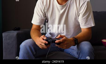 Man holding joystick in both hands Stock Photo