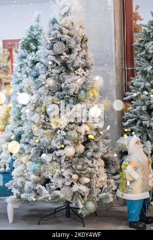 Christmas souvenirs and toys for decoration prepared for sale in store. Variety of white decoration in shopping center. New Year. Stock Photo