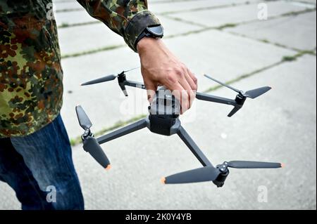 ZAPORIZHZHIA, UKRAINE - SEPTEMBER 8, 2022 - A man holds an UAV at the school of drone pilots organised by the volunteers of the Palianytsia Charity Fo Stock Photo