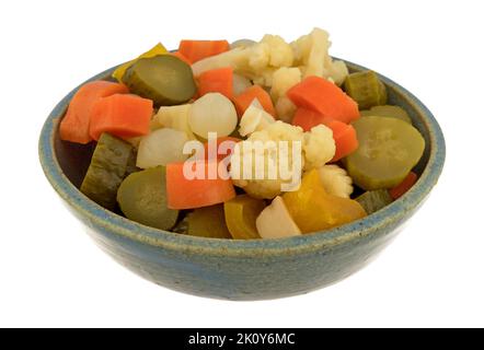 Side view of giardiniera pickled vegetables in a stoneware bowl isolated on a white background. Stock Photo