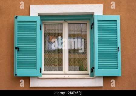 A closed windows with open blue blinds Stock Photo