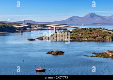 KYLE OF LOCHALSH KINTAIL SCOTLAND LATE SUMMER EILEAN BAN ISLAND AND  THE SKYE BRIDGE WITH CUILLINS IN THE DISTANCE Stock Photo