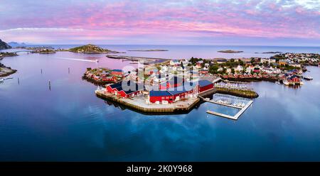 Reine, Lofoten, Norway. Traditional Norwegian fishing village with red wooden houses on small island with harbor and midnight sun. Nordic landscape, S Stock Photo