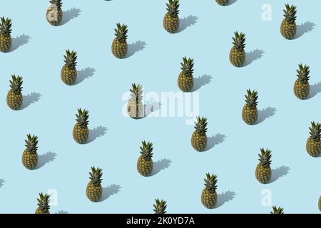 Summer pattern - pineapples on blue background. Minimal concept. Stock Photo