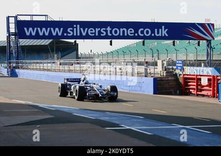 Wlliams Formula 1 car entering pits along pit lane driven by Alexander Wurz Silverstone Race Circuit UK 20 September 2006 Stock Photo