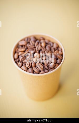 Close up shot of freshly roasted coffee beans in a cup. Stock Photo