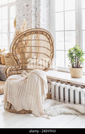 Wicker chair in the room.Boho style interior. Stock Photo