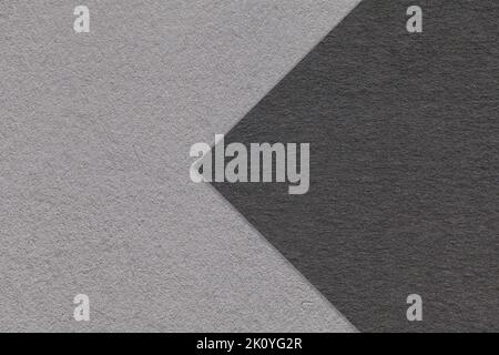 Texture of black and gray paper background, half two colors with arrow, macro. Structure of dense craft grey cardboard. Felt abstract backdrop closeup Stock Photo