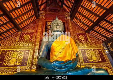 Statue of Buddha in small temple near Wat Chedi Luang temple, Thailand. Spiritual place with beautiful ornaments and textures. Famous tourist destinat Stock Photo