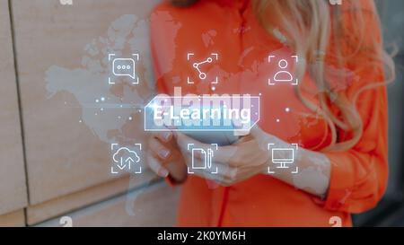 Online e-learning. Modern method of education. The person is holding a smartphone. Stock Photo