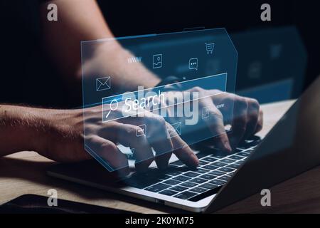 Internet search in the global Internet. The person is working behind a laptop and a holographic display. Stock Photo