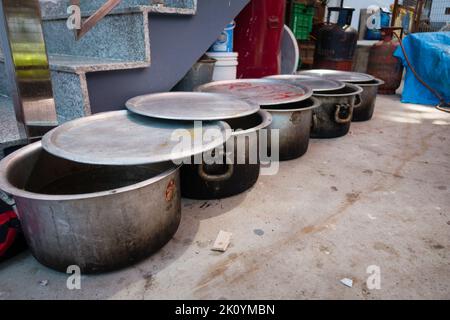 April 13th 2022, Dehradun City Uttarakhand India. Big stew pots or boilers lined up with food during a public feast. Commonly know as Pateela in India Stock Photo