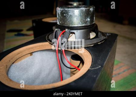April 13th 2022, Dehradun City Uttarakhand India. A dismantled speaker with exposed wiring and sub woofer unit driver with a large magnet. Stock Photo