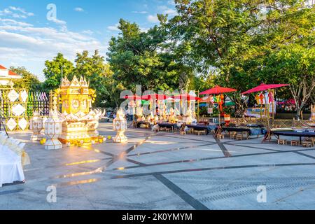 CHIANG MAI, THAILAND - 3.11.2019: Night market in Chiang Mai city shortly after sunset. Tourist are walking on the road. Thai sellers in the stall on Stock Photo