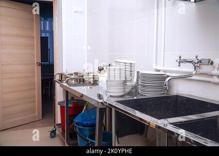 Clean washed dishes in the kitchen of a restaurant or cafe Stock Photo