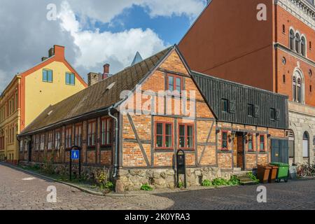 Ystad, Sweden 13 Sep, 2022:Old half timbered house with cobblestone infront on the street Stock Photo