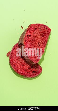 Beetroot purple bun slices on green background. Stock Photo